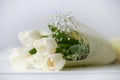 bouquet of white tulips on an antique white furniture