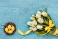 Bouquet of white tulips and decorative Easter eggs. Easter background,