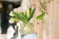 Bouquet of white tulips in a glass square Vahe in the decor and decoration of a wedding Royalty Free Stock Photo
