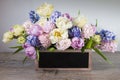 Bouquet of white tulips, pink and blue hyacinths in a wooden box with copy space for text Royalty Free Stock Photo