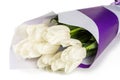 Bouquet of white tulips in a purple and white package