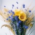 A bouquet of wild flowers of blue cornflowers and yellow spikelets,