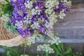 A bouquet of wild flowers in a braided basket Royalty Free Stock Photo