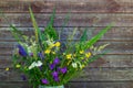 Bouquet of wild flowers on a wooden wall background. Old boards, Russian field. Royalty Free Stock Photo