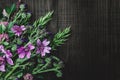 Bouquet of wild meadow flowers on dark wooden background. Royalty Free Stock Photo