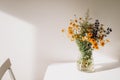 Colorful midsummer bunch of wildflowers. Bouquet of wild natural flowers in a vase on the table, selective focus. Summer wallpaper Royalty Free Stock Photo