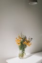 Colorful midsummer bunch of wildflowers. Bouquet of wild natural flowers in a vase on the table, selective focus. Summer wallpaper