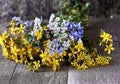 Bouquet of wildflowers against wooden floor
