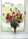 Bouquet of wildflowers on a plastic window
