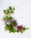 Bouquet wreath of lilac flowers on white wooden background. Royalty Free Stock Photo