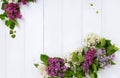 Bouquet wreath of lilac flowers on white wooden background. Royalty Free Stock Photo