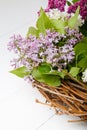 Bouquet wreath of lilac flowers on white wooden background. Royalty Free Stock Photo