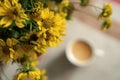 bouquet of yellow autumn flowers. autumn background, heliopsis and a blurred cup of coffee Royalty Free Stock Photo