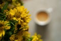 bouquet of yellow autumn flowers. autumn background, heliopsis and a blurred cup of coffee Royalty Free Stock Photo