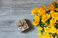 Bouquet of yellow chrysanthemums on a background of a gift with