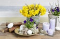 Bouquet of yellow daffodils and floral arrangement with pansy flowers, moss and eggs Royalty Free Stock Photo