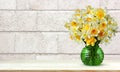 Bouquet of yellow daffodils on a light background of a wall of blocks Royalty Free Stock Photo