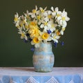 Bouquet of yellow daffodils on the table with a lace tablecloth. Royalty Free Stock Photo