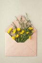 Bouquet of yellow flowers and blank on pastel background, beautiful breakfast, vintage romantic card, top view, flat lay, rustic Royalty Free Stock Photo