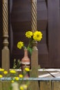 Bouquet of yellow flowers in a clay jug vase on a wooden background Royalty Free Stock Photo