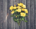 Bouquet of yellow garden roses on rustic weathered wooden backgr Royalty Free Stock Photo