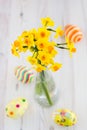 Bouquet of yellow lent lilly (daffodil) with easter eggs on a wooden surface Royalty Free Stock Photo