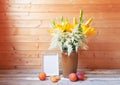 Bouquet of yellow lilies and white astilbe in clay vase, empty frame and fresh fruits near Royalty Free Stock Photo