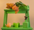 Bouquet of yellow-orange hyacinths on a green stand with spring decorations Royalty Free Stock Photo