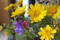 Bouquet of yellow and purple wildflowers. Glebionis segetum. Corn marigold and daisy