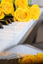 A bouquet of yellow roses on the piano. Musical Concept. Background. Copy Space