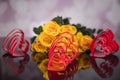 A bouquet of yellow roses and red plastic hearts. Valentine`s Day Royalty Free Stock Photo