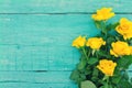 Bouquet of yellow roses on turquoise rustic wooden background. V Royalty Free Stock Photo