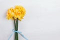 A bouquet of yellow spring flowers on the white wooden background Royalty Free Stock Photo