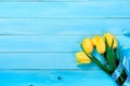 Bouquet of yellow tulips on a blue wooden background Royalty Free Stock Photo