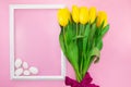 Bouquet of yellow tulips with bow with frame and white stones on pink background. Holiday, Birthday, March 8, Mother`s Royalty Free Stock Photo