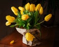 A bouquet of yellow tulips isolated dark