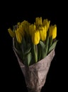 Bouquet of yellow tulips in paper with notes on a black background Royalty Free Stock Photo