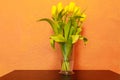 Bouquet of yellow tulips in a vase on table Royalty Free Stock Photo