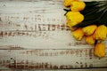 Bouquet of yellow tulips on white wooden background Royalty Free Stock Photo