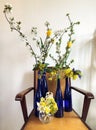 Bouquets of flowers in blue glass bottles
