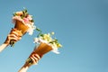 Bouquets of flowers in two hand and blue sky. Women family lgtb. Wedding day. Florist. Copy space Royalty Free Stock Photo