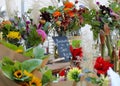 Colorful boquets of fresh-cut flowers in jars on display at a market Royalty Free Stock Photo