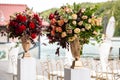 Bouquets of roses placed in vases for the deor on the wedding day. Outdoor ceremony. Royalty Free Stock Photo