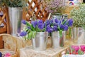 Bouquets of violet beautiful hyacinth flowers in metal vases stand on a counter Royalty Free Stock Photo