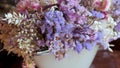 Bouquets with white, purple and violet dried flowers and leaves for sale in flower shop.