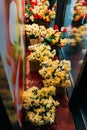 bouquets of yellow daffodils and red tulips stand in flower beds on a glass showcase Royalty Free Stock Photo