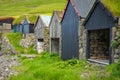 Bour village. Typical grass-roof houses and green mountains. Vagar island, Faroe Islands. Denmark. Europe