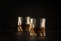 Bourbon in glass, american corn whiskey, dark bar counter, selective focus