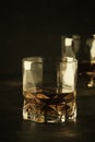 Bourbon in glass, american corn whiskey, dark bar counter, selective focus