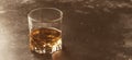 Bourbon in glass, american corn whiskey, dark bar counter, selective focus